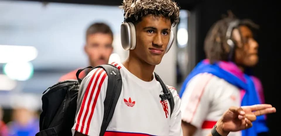 Player wearing headphones walking in team tunnel