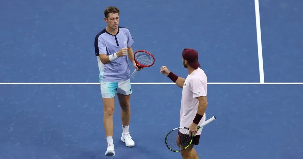 Two tennis players celebrating a point on court