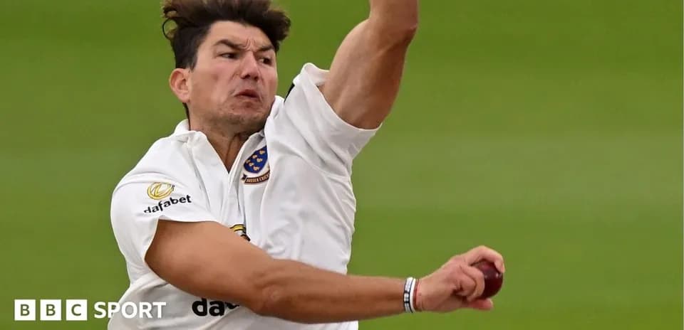 Cricketer bowling during a match