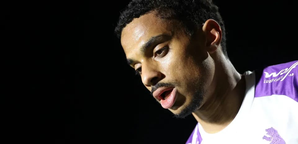 Player looking down, wearing a team jersey