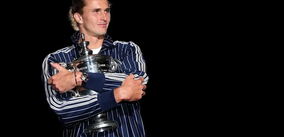 Player holding trophy in striped jacket