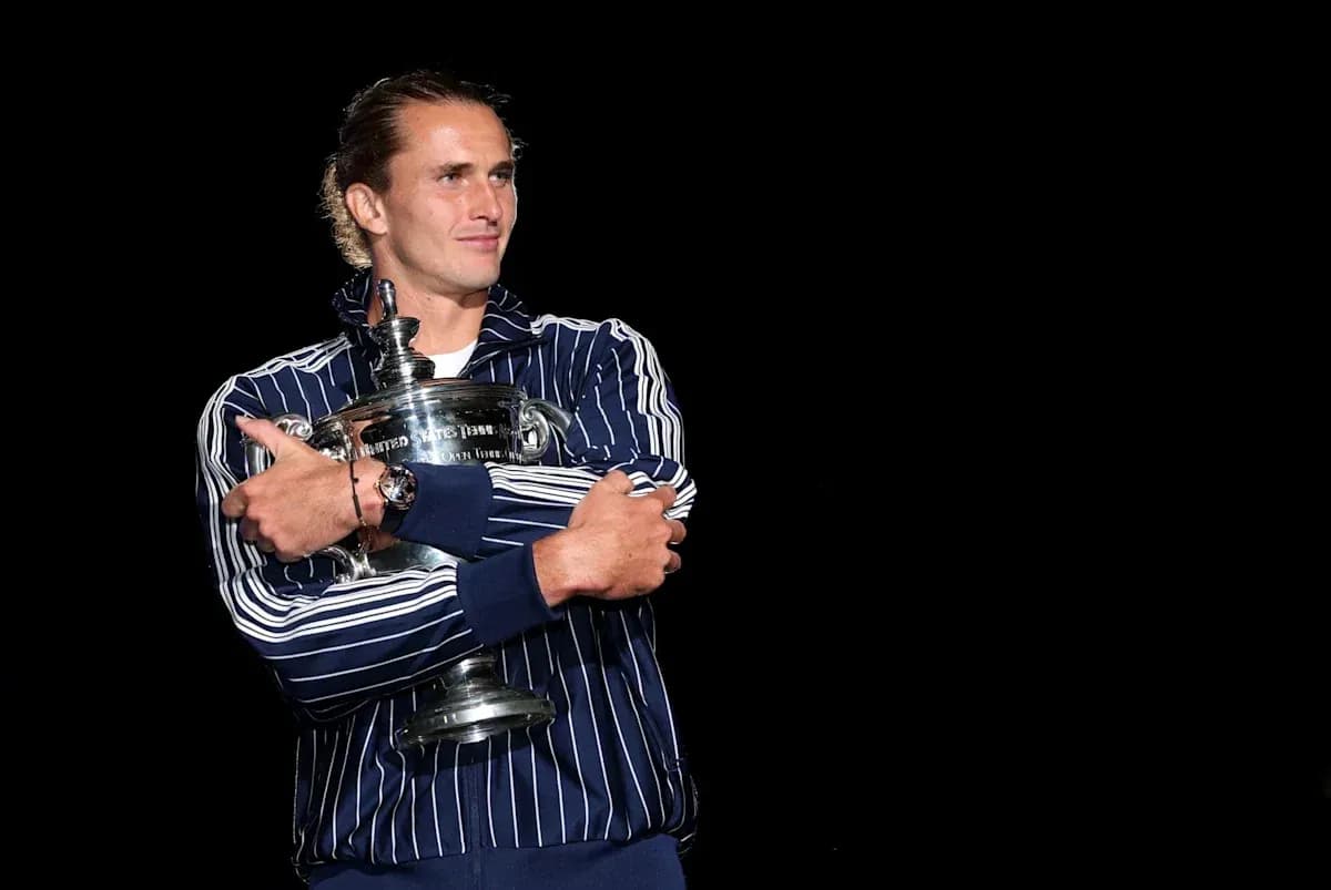 Player holding trophy in striped jacket