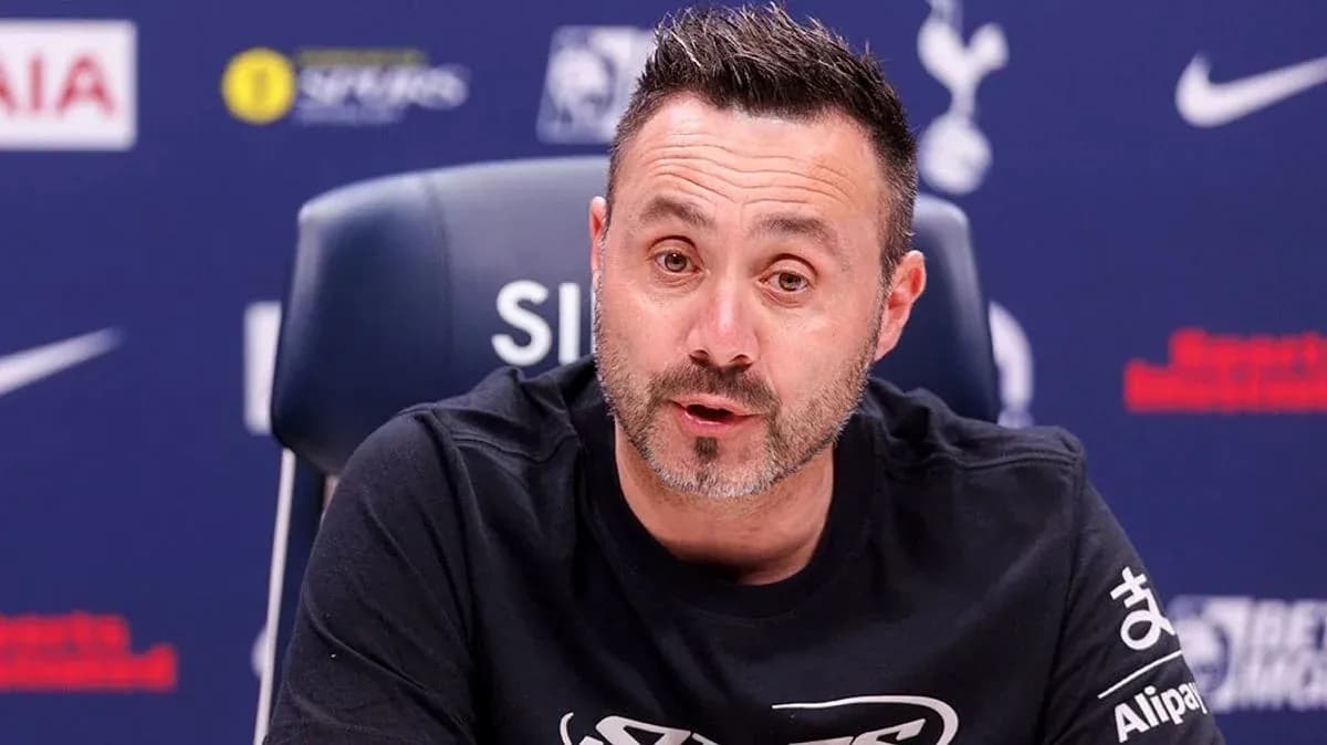 Manager speaking at press conference with team logo