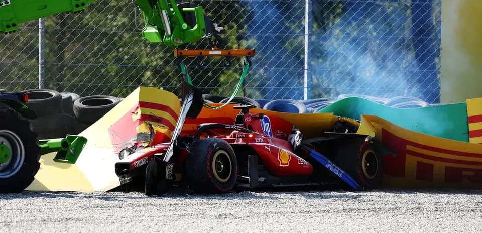 Crushed Ferrari car being lifted by a crane