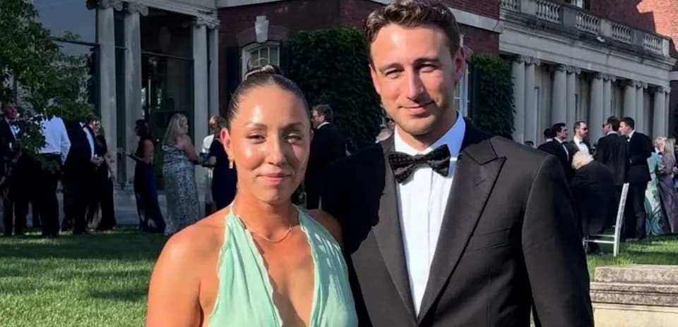 Couple posing at outdoor event in formal attire