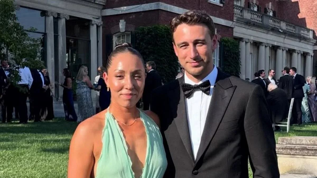 Couple posing at outdoor event in formal attire