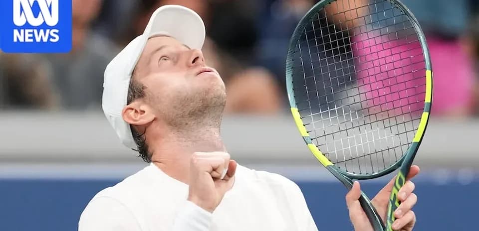 Tennis player celebrating victory with racket raised