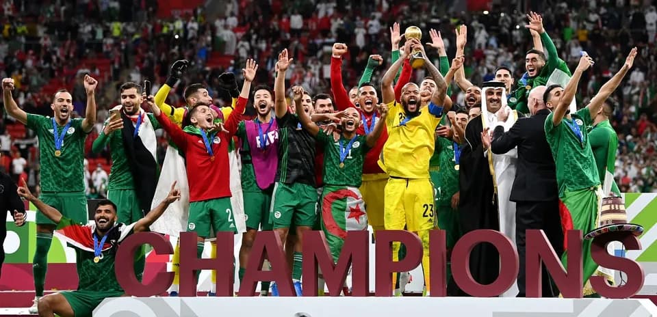 Algerian team celebrating victory with trophy