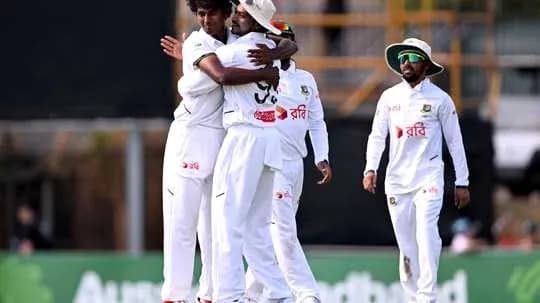Players celebrating a wicket during cricket match