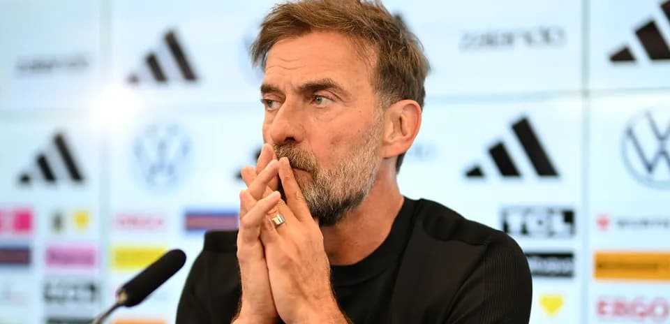 Manager at press conference with microphone and logos