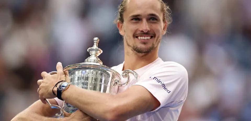 Player holding trophy after winning tennis championship