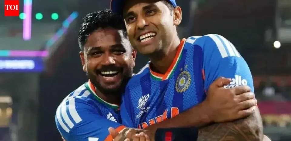Two cricketers celebrating in team jerseys