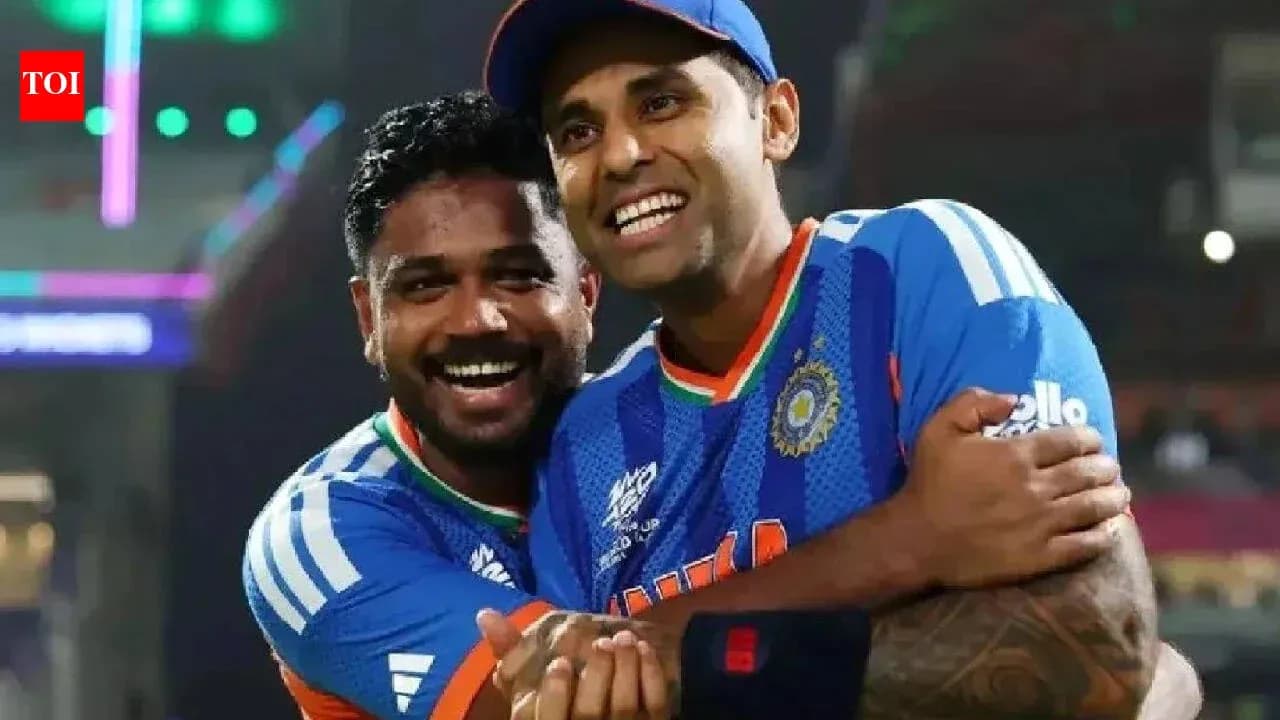 Two cricketers celebrating in team jerseys