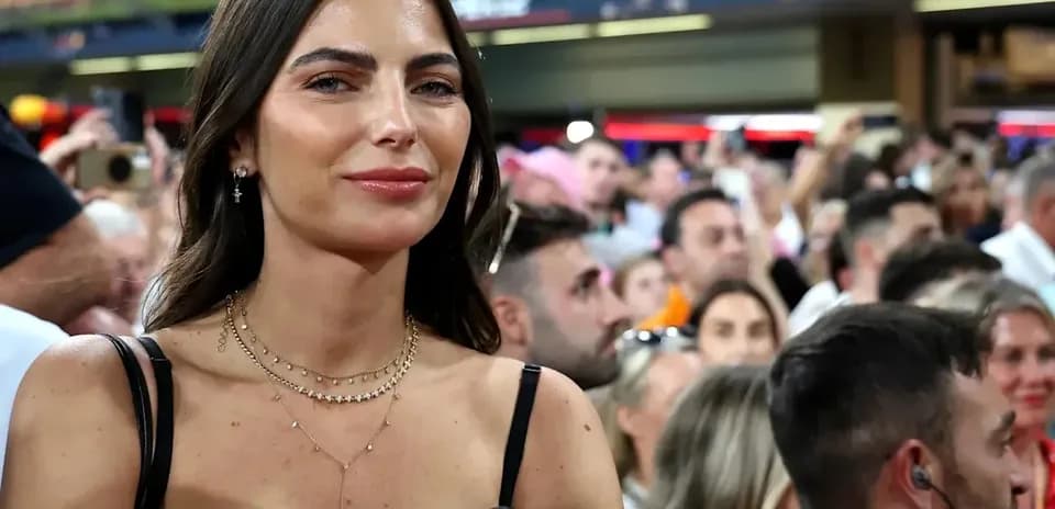 Woman smiling among a crowd at an event