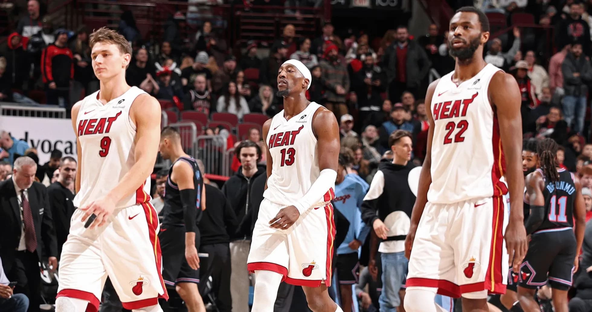 Three Miami Heat players walking off the court