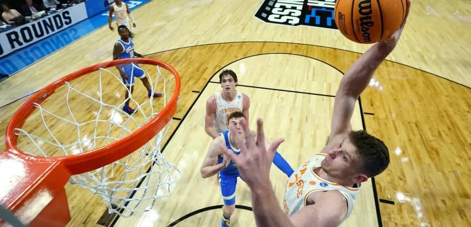 Player dunking during NCAA basketball tournament game