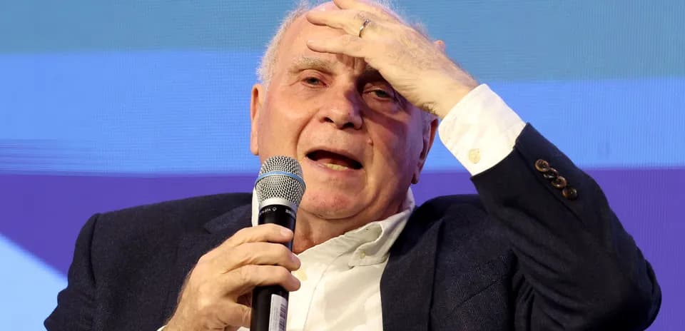 Man speaking into microphone during discussion event