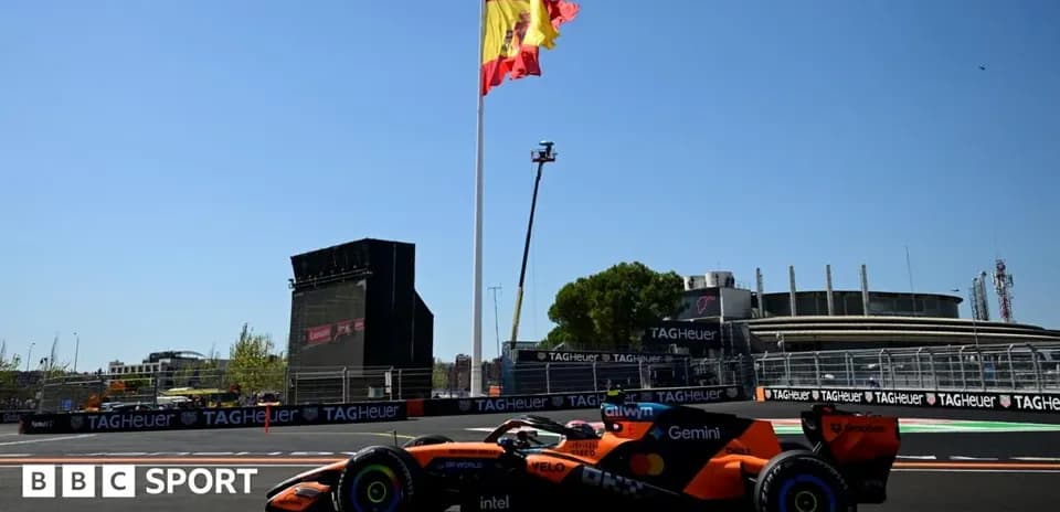 Formula 1 car racing near Spanish flag at circuit