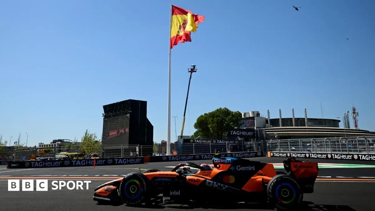 Formula 1 car racing near Spanish flag at circuit