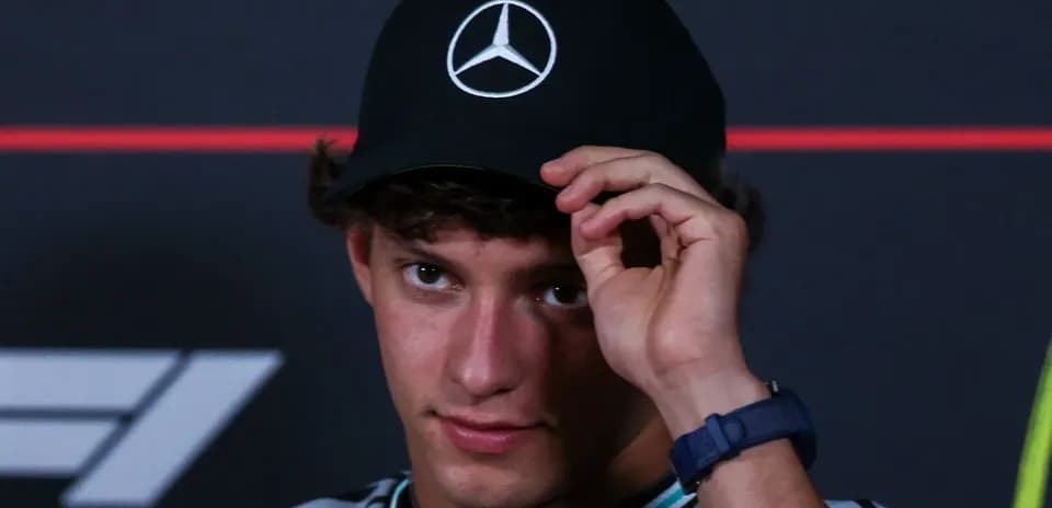 Young driver adjusting his Mercedes cap at event