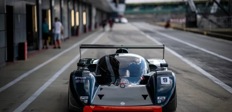 Race car in the pit lane at a racetrack
