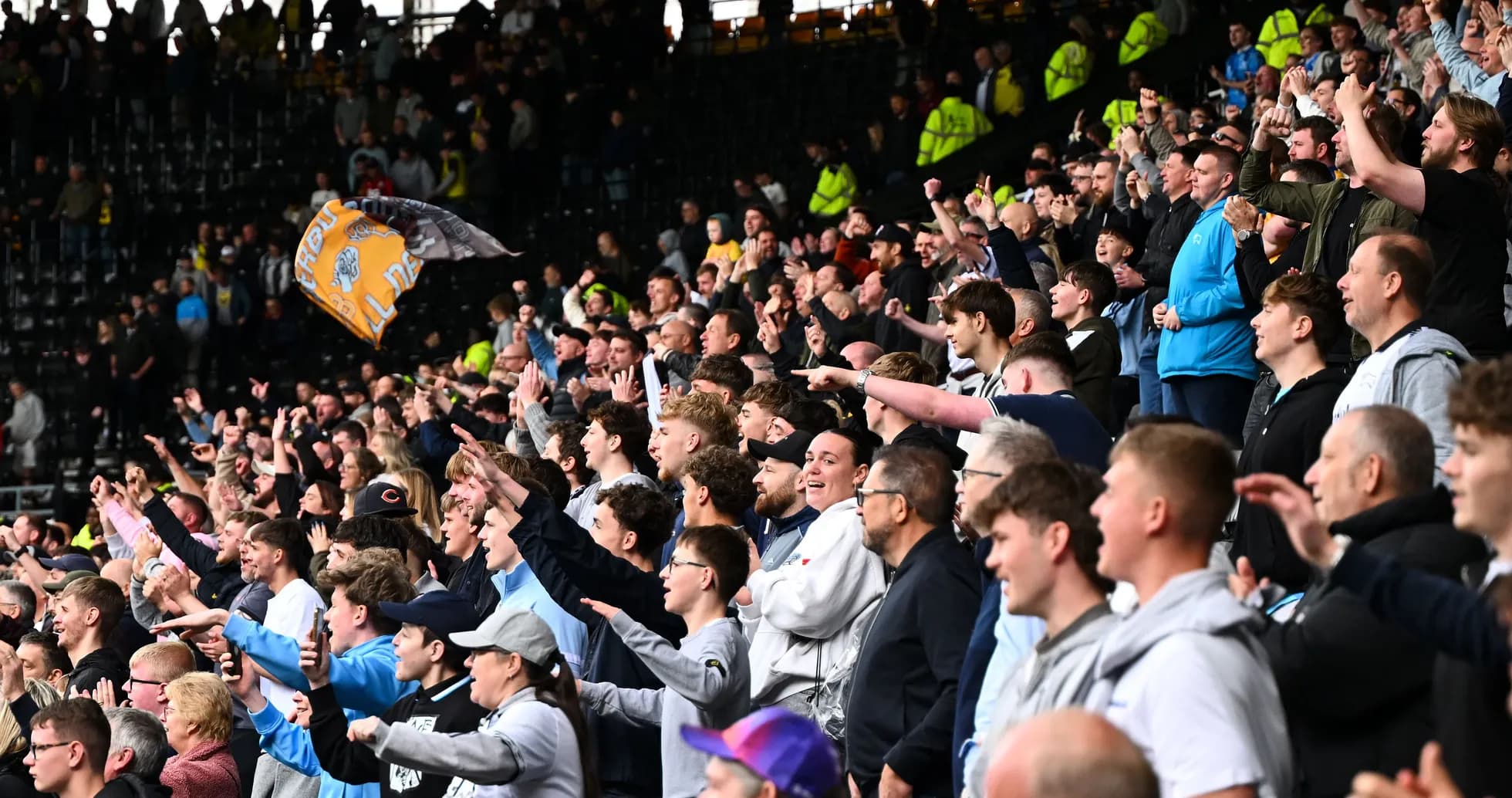Crowd of fans cheering in the stadium stands