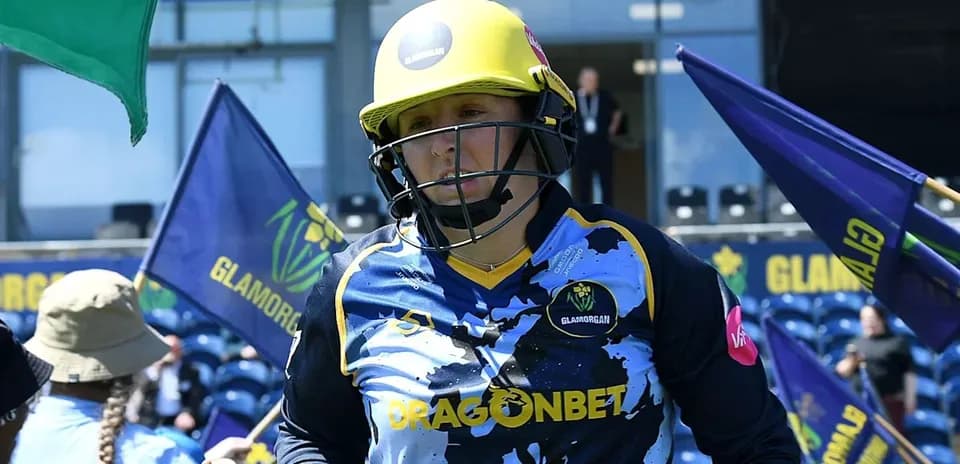 Cricketer from Glamorgan entering the field with flags