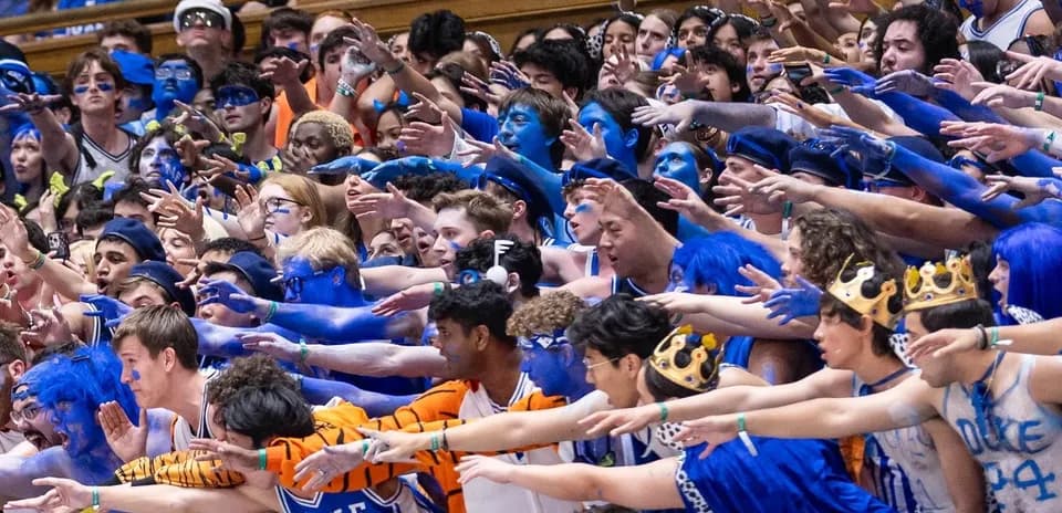 Duke fans in blue body paint cheering during game