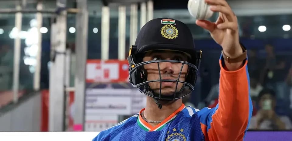 Cricketer holding a ball, preparing for play