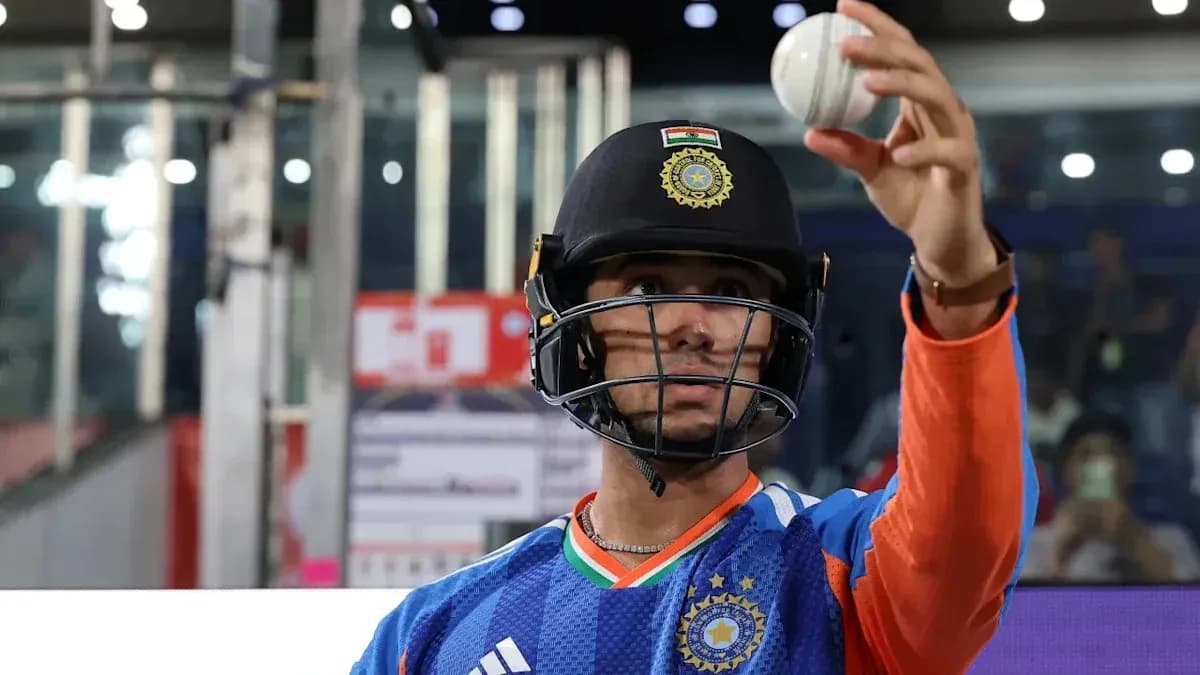 Cricketer holding a ball, preparing for play