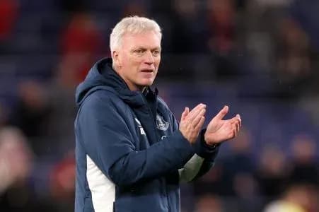 Manager clapping on the sidelines during match