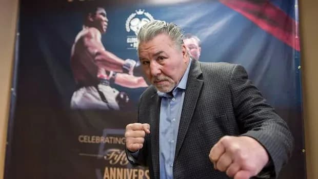 Former boxer posing with fists raised