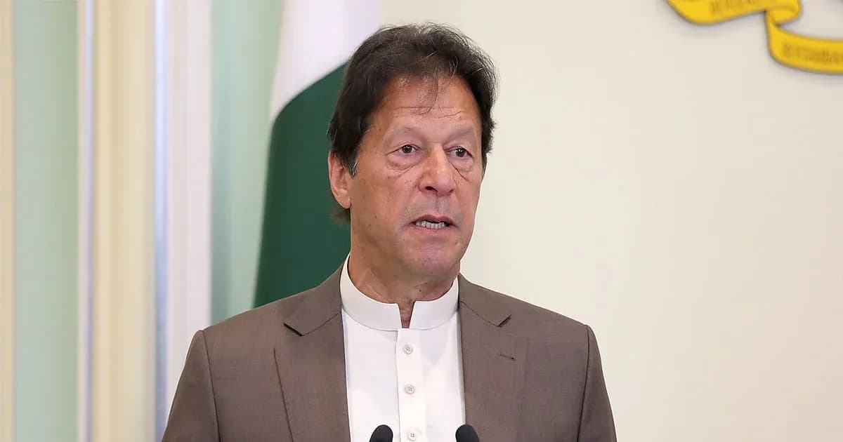 Person speaking at a podium with national flag behind