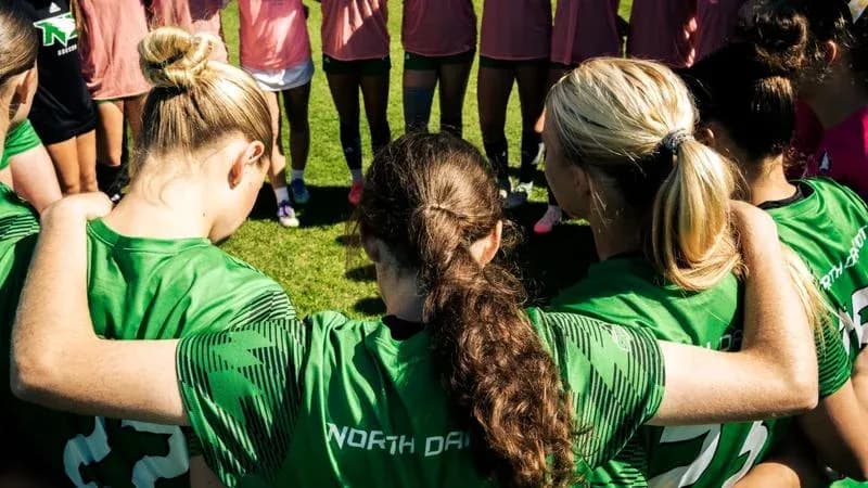 Players huddled together in team huddle