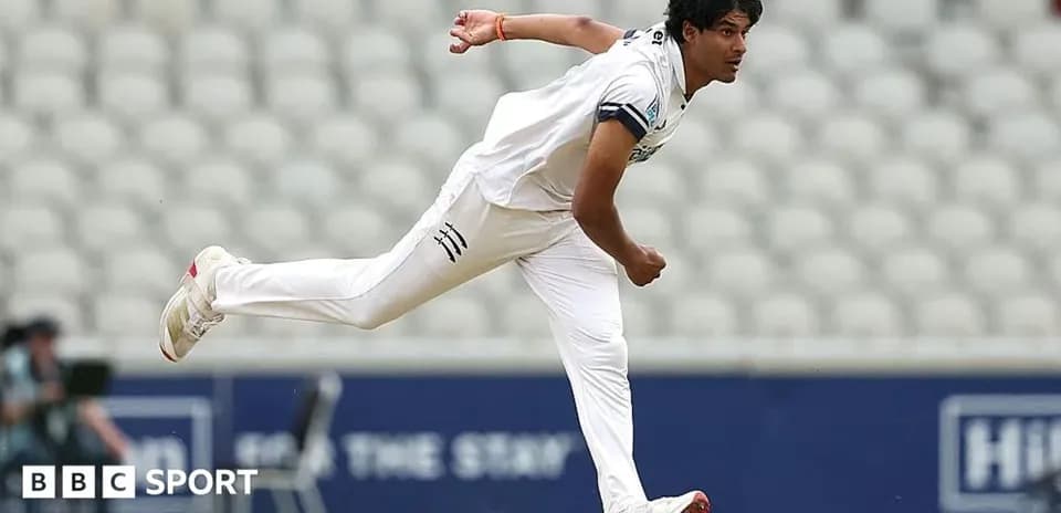 Cricketer bowling during a match on the field