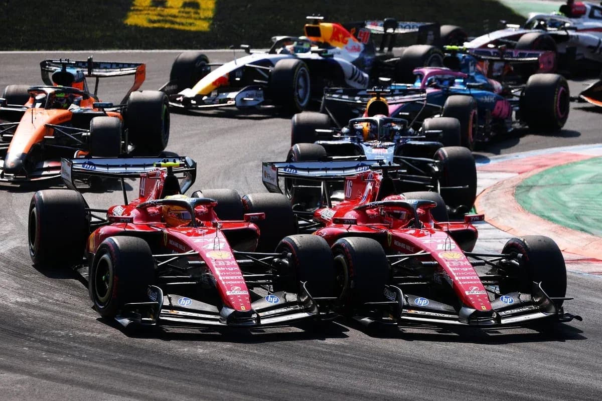 Two Ferrari cars racing closely during Formula 1 event