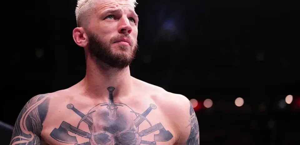 Fighter with tattoos preparing for match in arena