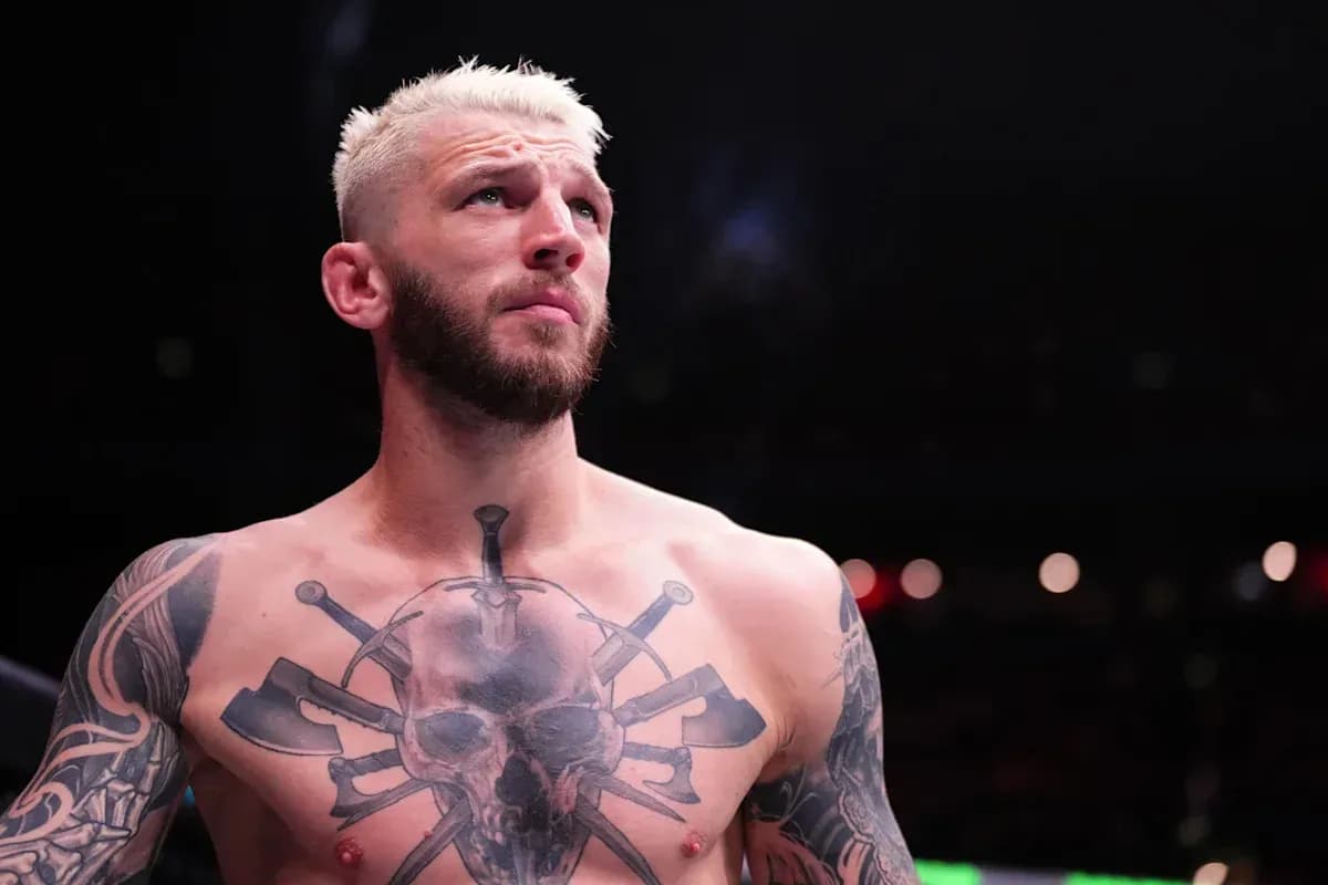 Fighter with tattoos preparing for match in arena