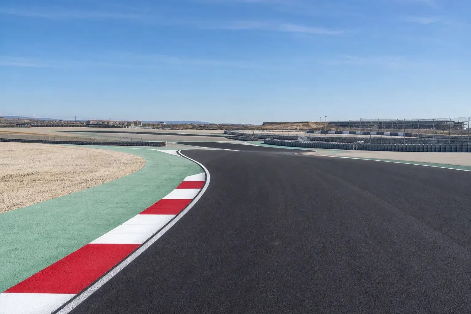 Curved racetrack with red and white curbing
