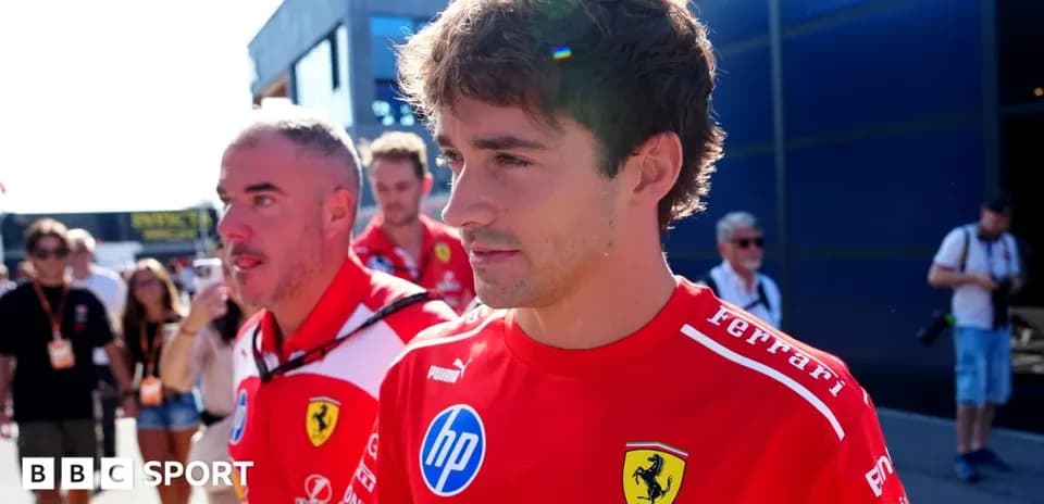 Ferrari team members walking in paddock area