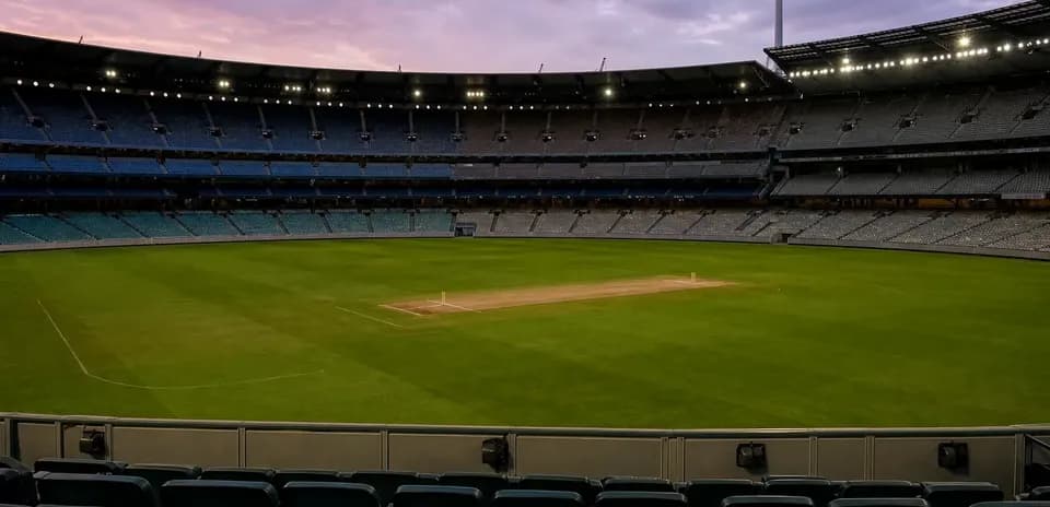Empty cricket stadium with pitch and seating