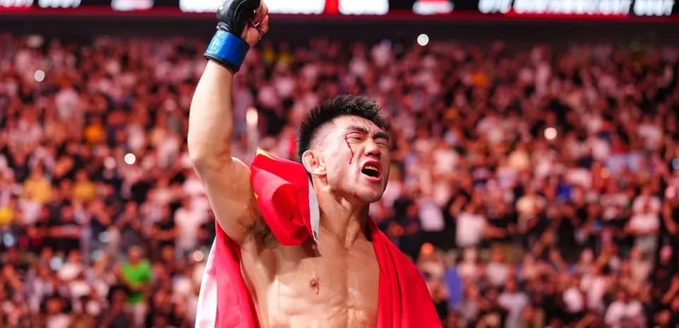 Fighter celebrating with a flag after victory