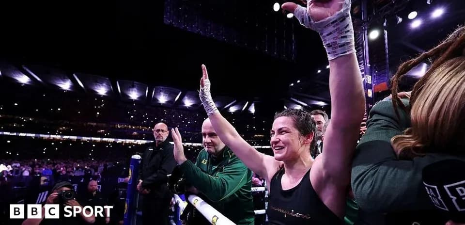 Female boxer celebrating in the ring after victory