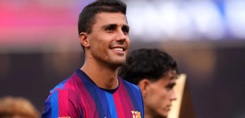 Player in FC Barcelona jersey smiling during celebration