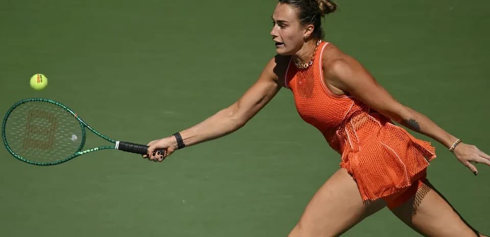 Female tennis player reaching for a ball