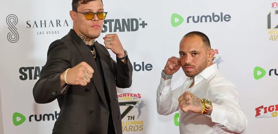 Two fighters posing with fists raised at event
