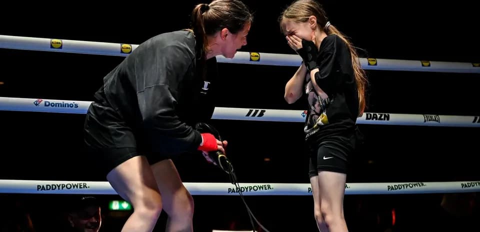 Boxer comforting a young girl in the ring