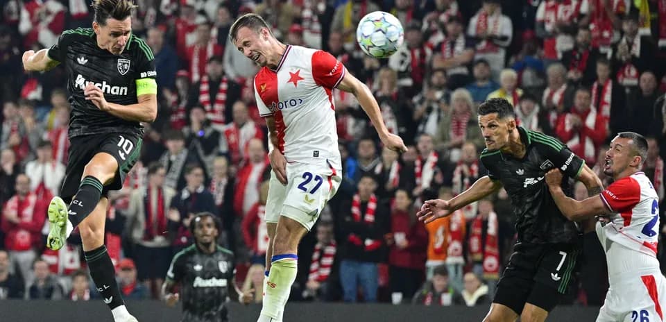 Players contesting a header during a football match
