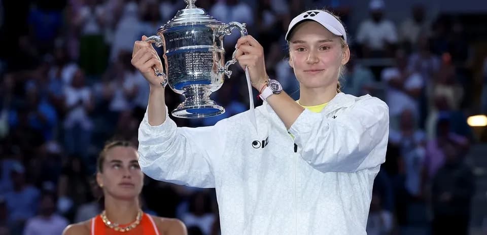 Player holding trophy after winning tennis match