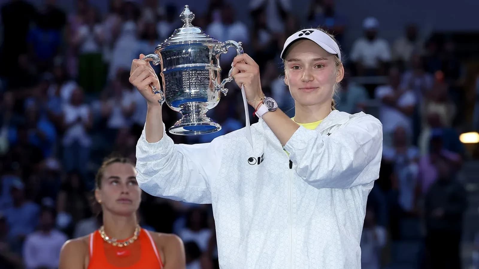 Player holding trophy after winning tennis match